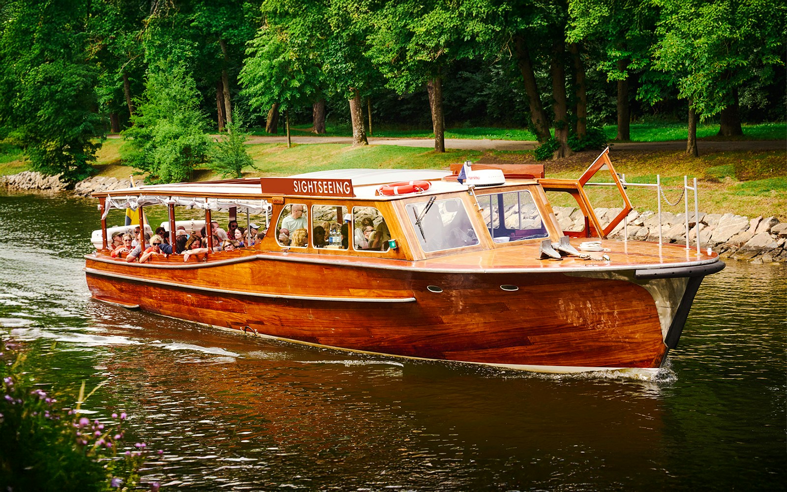 Classic wooden sightseeing boat cruising Stockholm Archipelago.