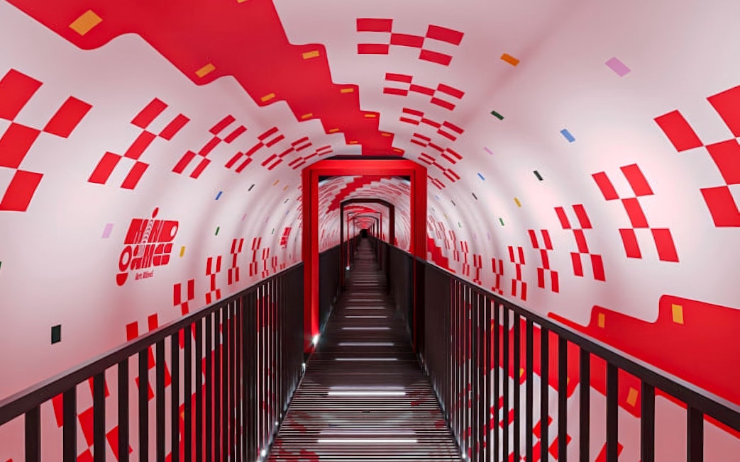 Tunnel with red geometric patterns at Mind Games - Art Alive! exhibit.