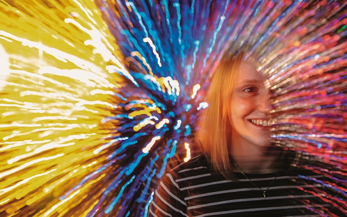 Person experiencing colorful light effects at Infinity Corridor, Camera Obscura & World of Illusions, Edinburgh.