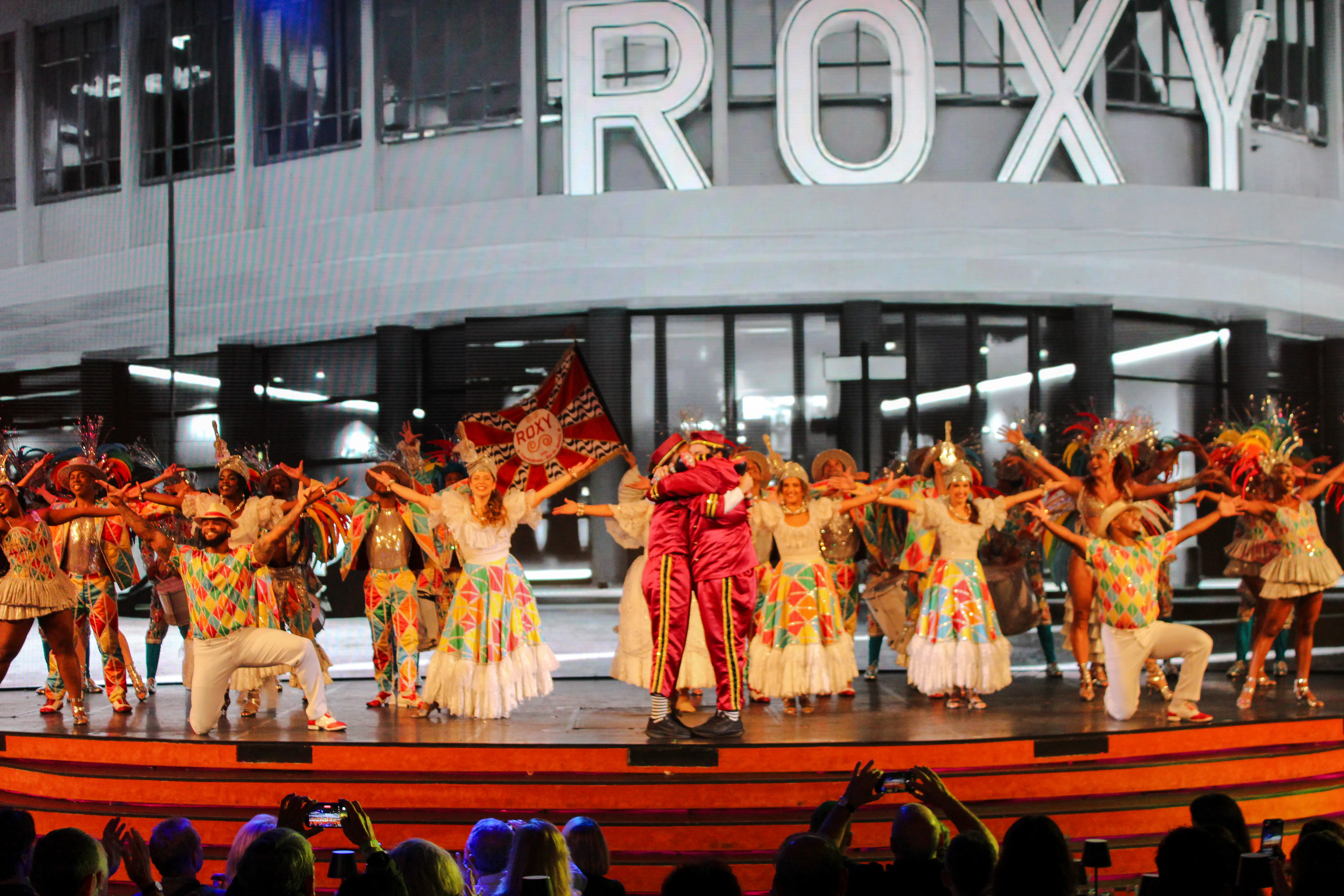 Performers in colorful costumes on stage at Roxy Dinner Show, Rio de Janeiro.