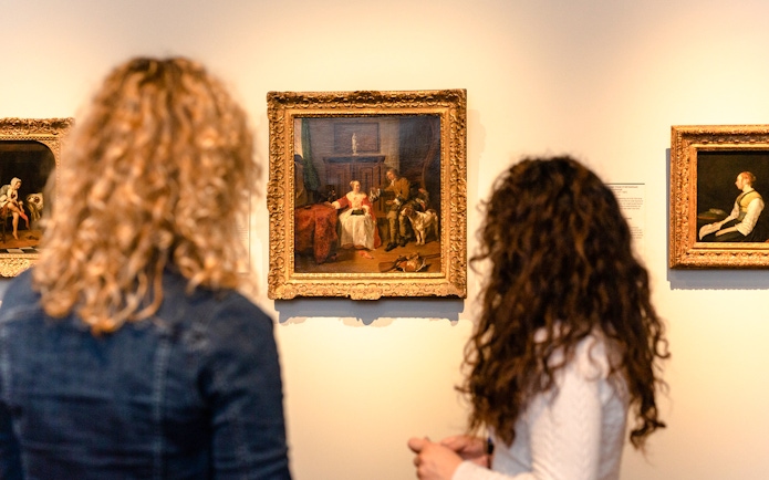 Visitors viewing paintings during a small group tour at the Rijksmuseum.