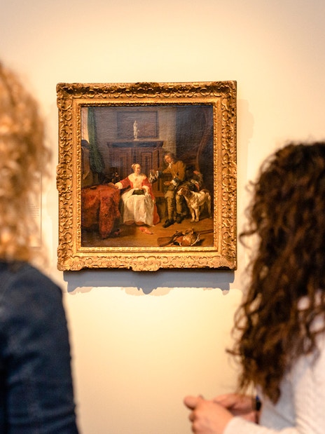 Visitors viewing paintings during a small group tour at the Rijksmuseum.