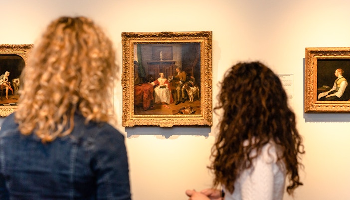 Visitors viewing paintings during a small group tour at the Rijksmuseum.