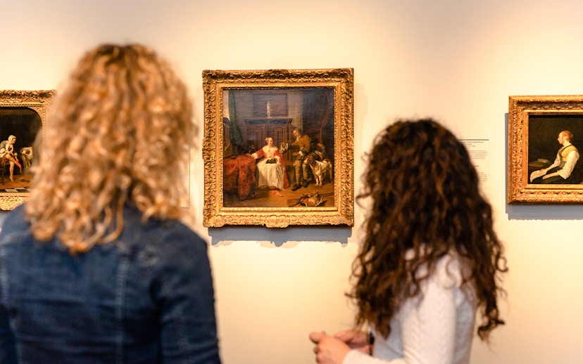 Visitors viewing paintings during a small group tour at the Rijksmuseum.