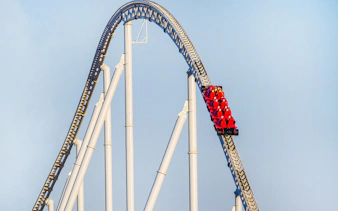 Roller coaster at Ferrari World Abu Dhabi with red cars on a steep track.