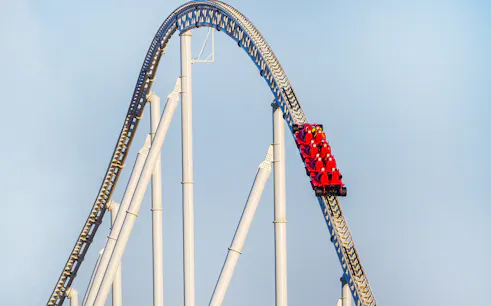 Roller coaster at Ferrari World Abu Dhabi with red cars on a steep track.