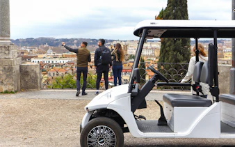 Golf cart parked with tourists overlooking Rome's skyline on the Eternal City Highlights Tour.