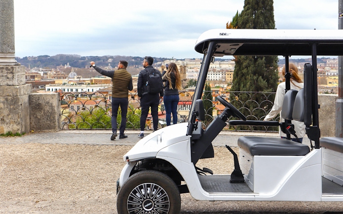 Golf cart parked with tourists overlooking Rome's skyline on the Eternal City Highlights Tour.