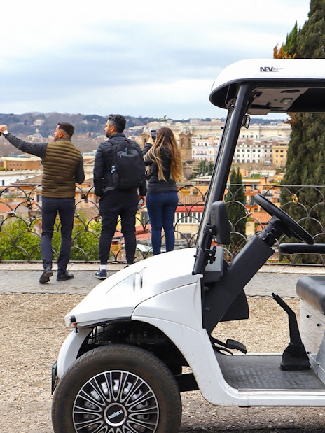 Golf cart parked with tourists overlooking Rome's skyline on the Eternal City Highlights Tour.