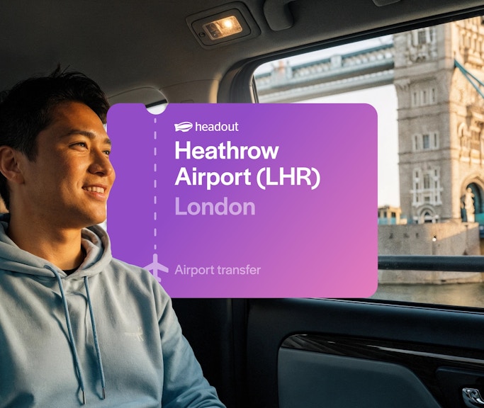 Man in taxi with view of Tower Bridge, London.