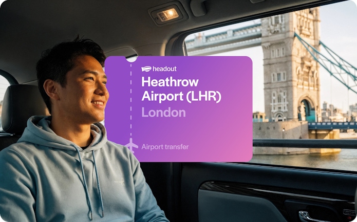 Man in taxi with view of Tower Bridge, London.