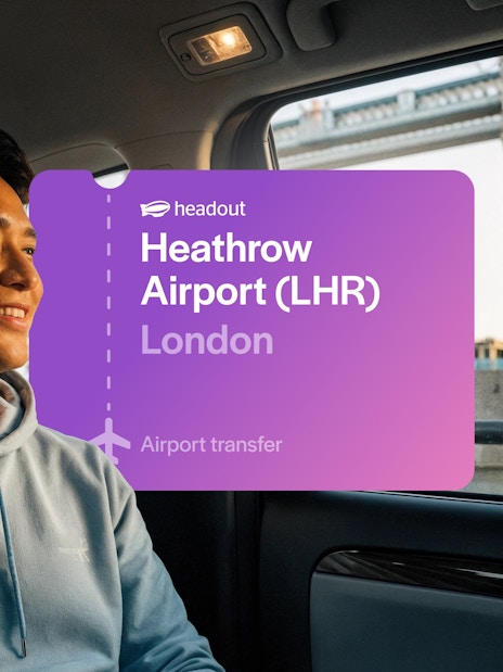 Man in taxi with view of Tower Bridge, London.