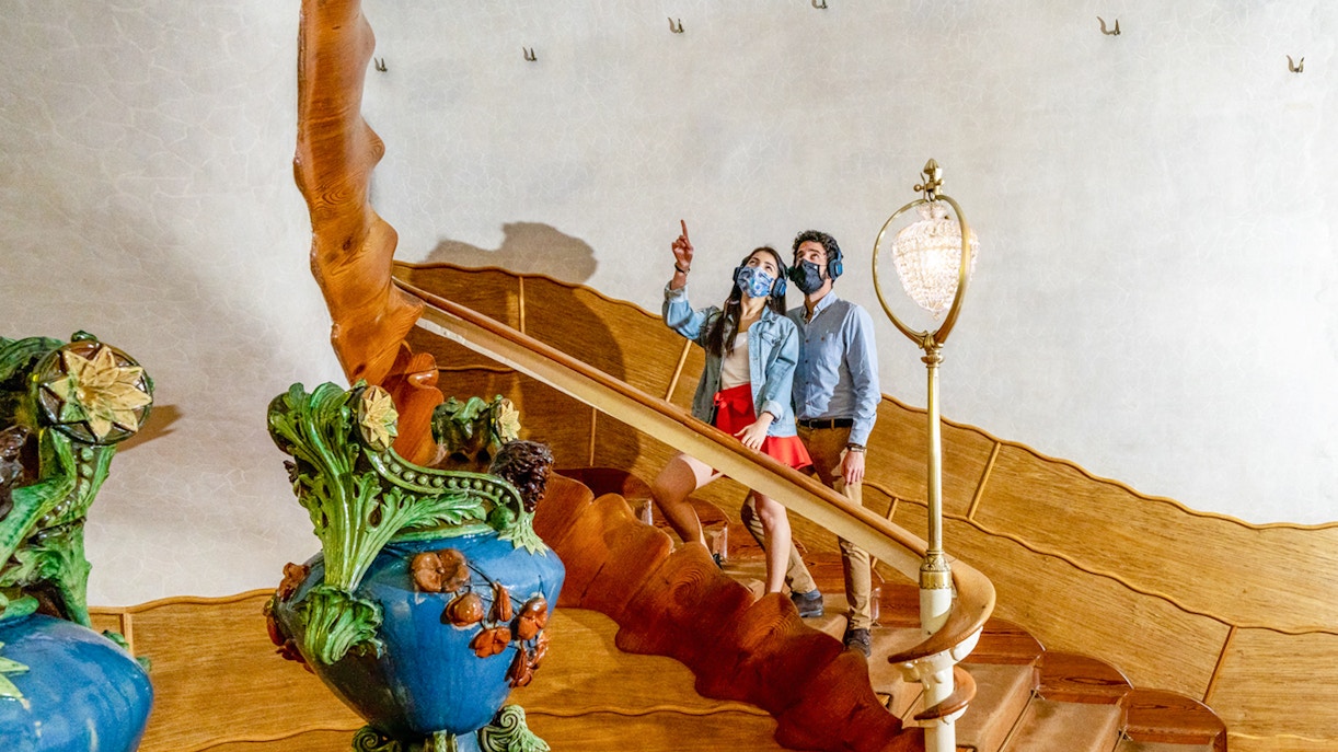 Visitors exploring the ornate staircase of Casa Batlló in Barcelona.