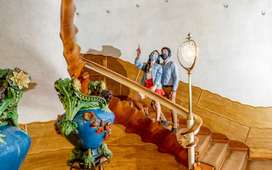 Visitors exploring the ornate staircase of Casa Batlló in Barcelona.