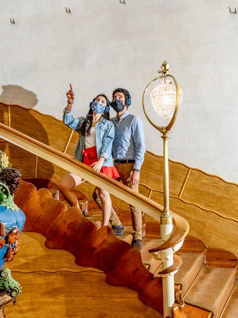 Visitors exploring the ornate staircase of Casa Batlló in Barcelona.