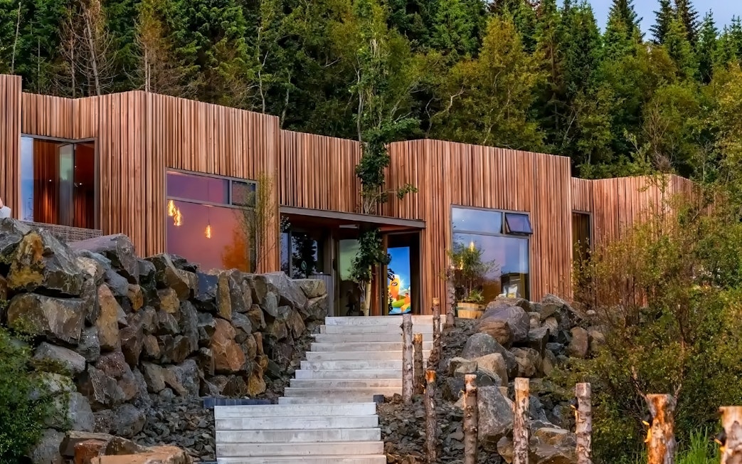 Forest Lagoon geothermal spa entrance surrounded by trees in Vaðlaskógur forest, near Akureyri, North Iceland.