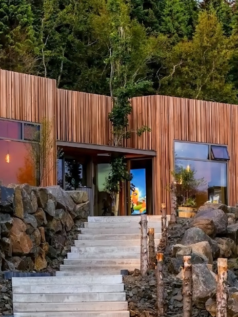 Forest Lagoon geothermal spa entrance surrounded by trees in Vaðlaskógur forest, near Akureyri, North Iceland.