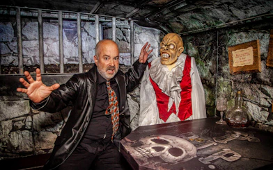 Man posing with a ghoul figure on the Dublin Ghostbus Tour.