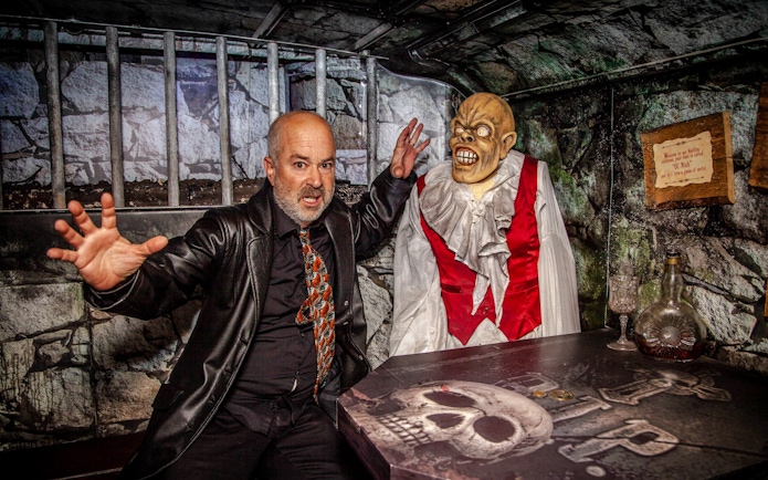 Man posing with a ghoul figure on the Dublin Ghostbus Tour.