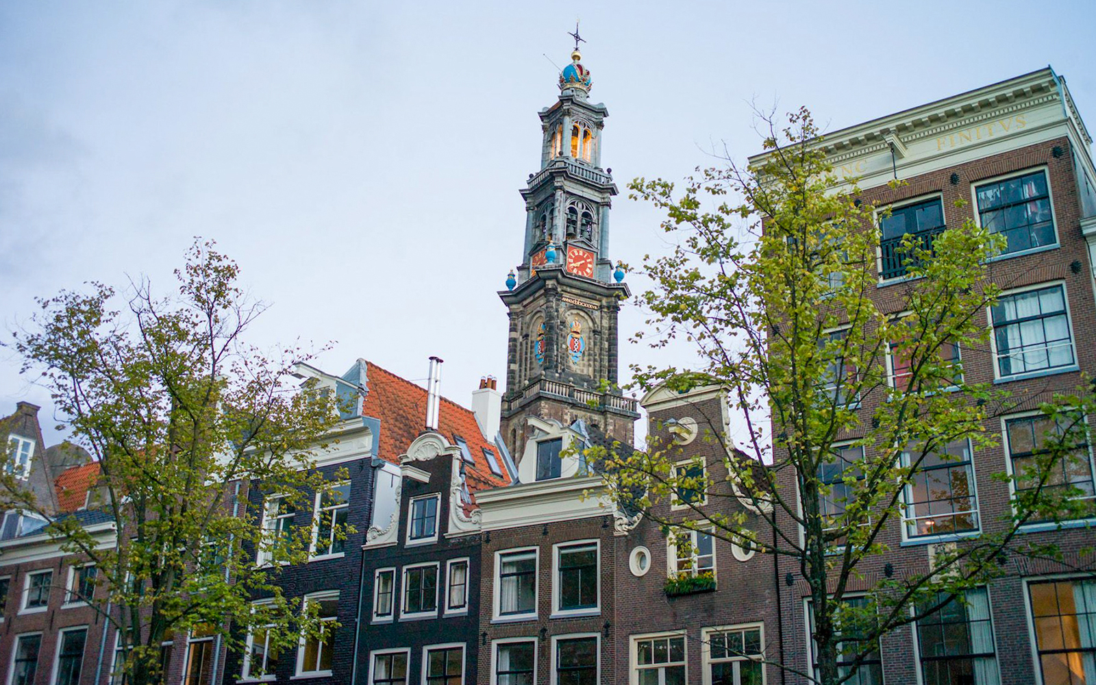 Westerkerk tower and traditional Dutch buildings in Amsterdam.