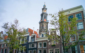 Westerkerk tower and traditional Dutch buildings in Amsterdam.
