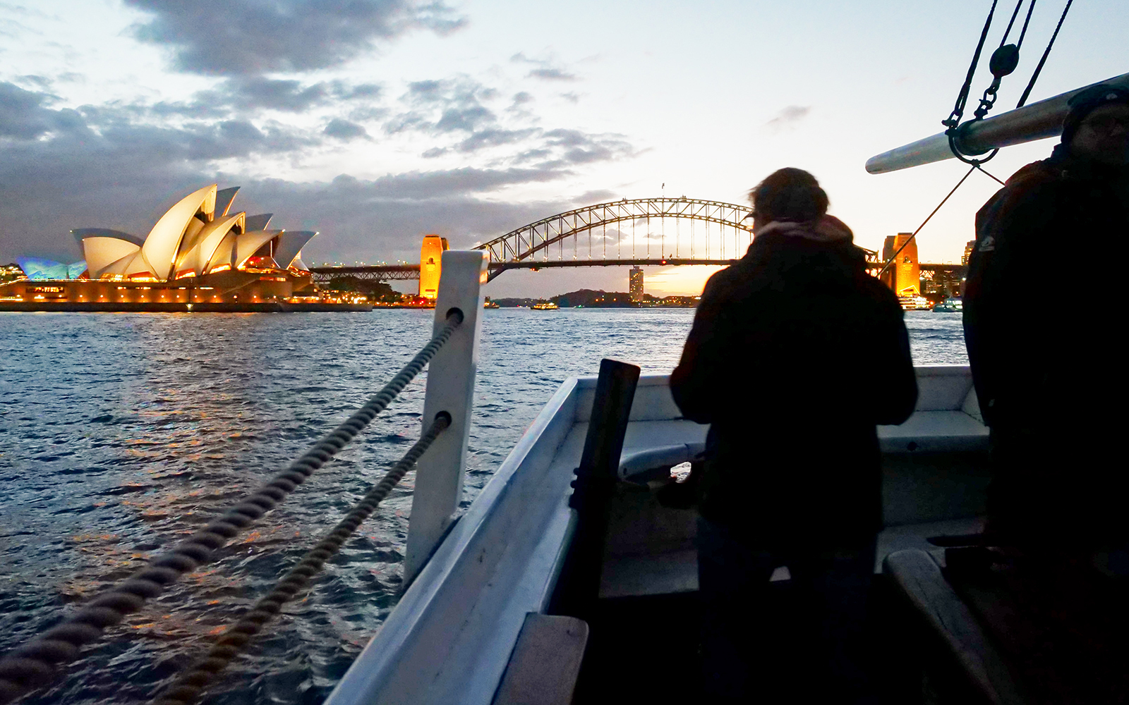 Tall ship cruise on Sydney Harbour with views of the Opera House and Harbour Bridge at sunset.