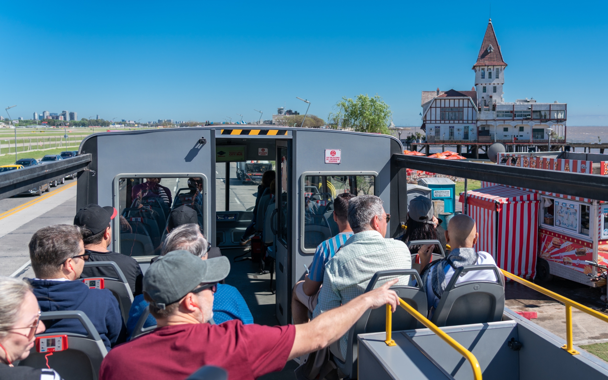 Tourists on Buenos Aires Hop-on Hop-off Bus viewing Club de Pescadores.