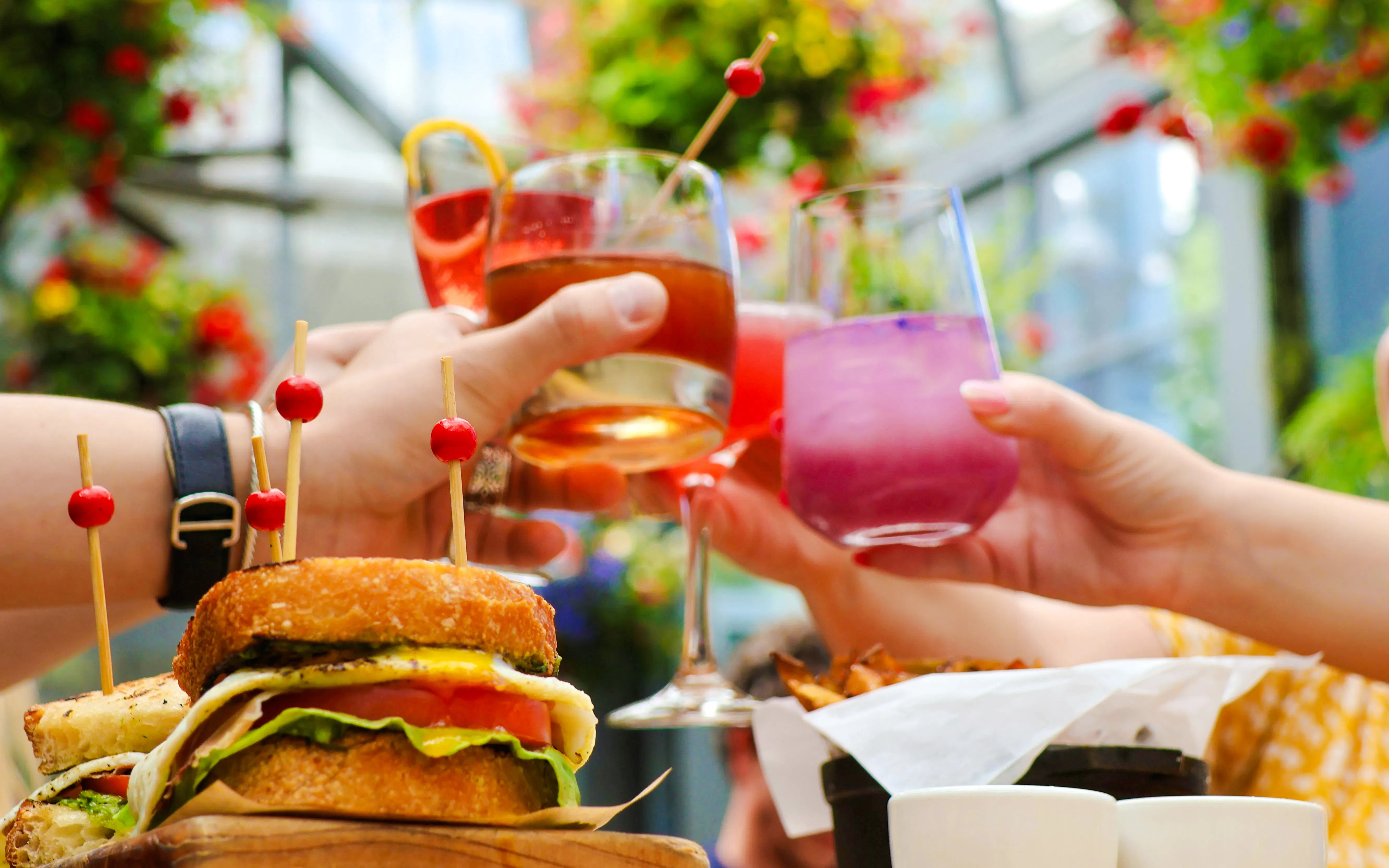 Guests toasting with drinks and enjoying food at Chihuly Garden and Glass, Seattle.