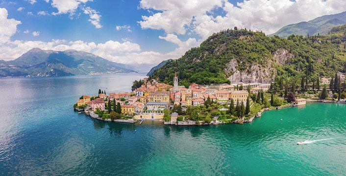 Panoramic view of Lake Como with surrounding mountains and lush greenery.