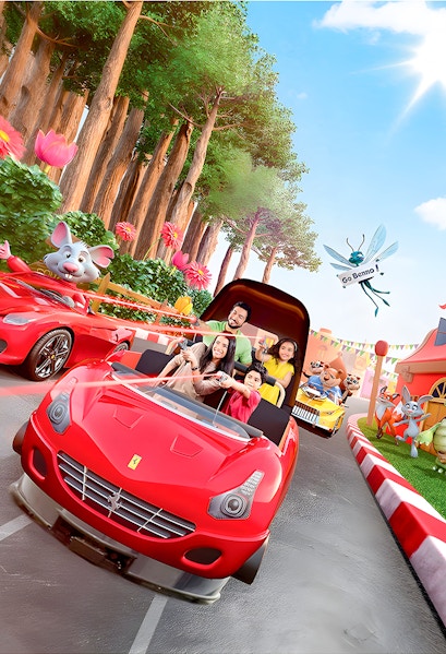 Family enjoying a ride in a red car at Ferrari World Theme Park, surrounded by animated characters.
