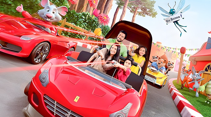 Family enjoying a ride in a red car at Ferrari World Theme Park, surrounded by animated characters.