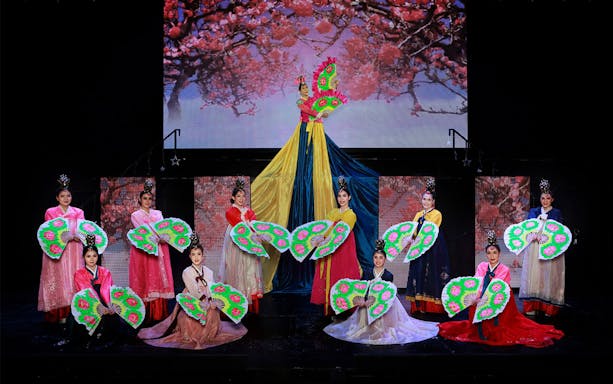 Performers in traditional costumes with fans at Siam Dragon Cabaret Show.