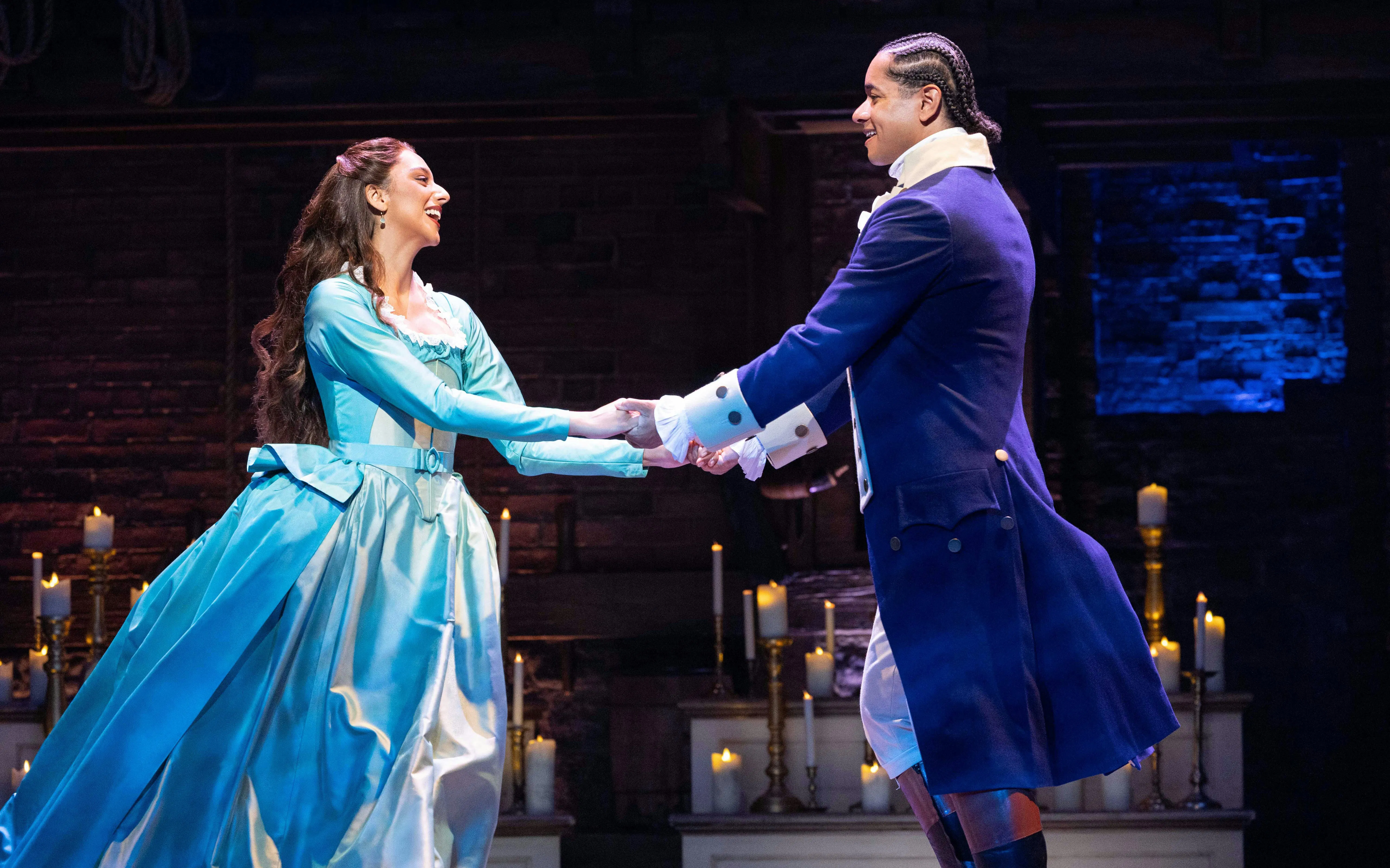 Actors performing a scene from Hamilton in West End theater.
