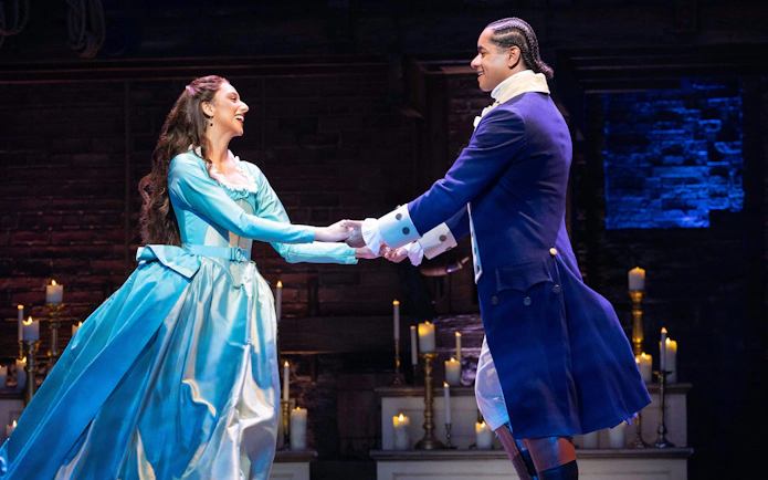 Actors performing a scene from Hamilton in West End theater.