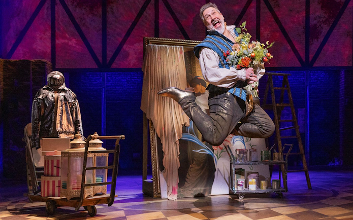 Performer jumping with flowers on stage during & Juliet musical.