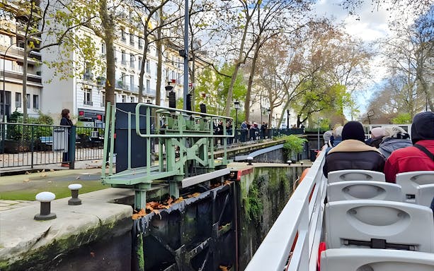 Seine River canal cruise boat passing through a lock in Paris, France.