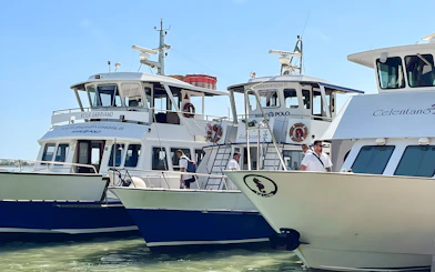 Boats docked for round-trip tickets to Venice, Italy.