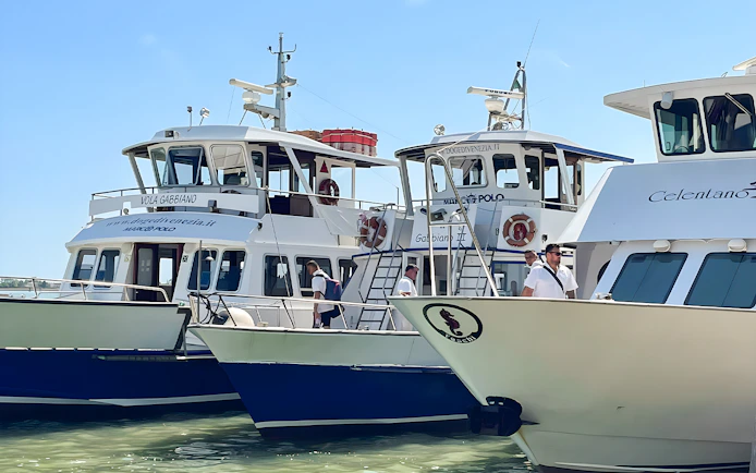 Boats docked for round-trip tickets to Venice, Italy.