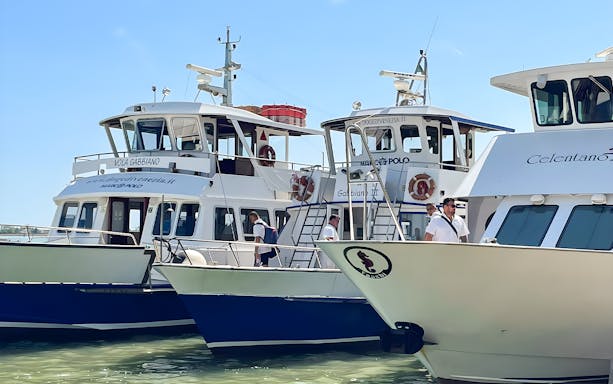 Boats docked for round-trip tickets to Venice, Italy.