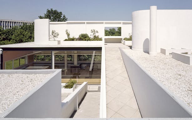 Terrace view of Villa Savoye showcasing modern architecture and garden elements.