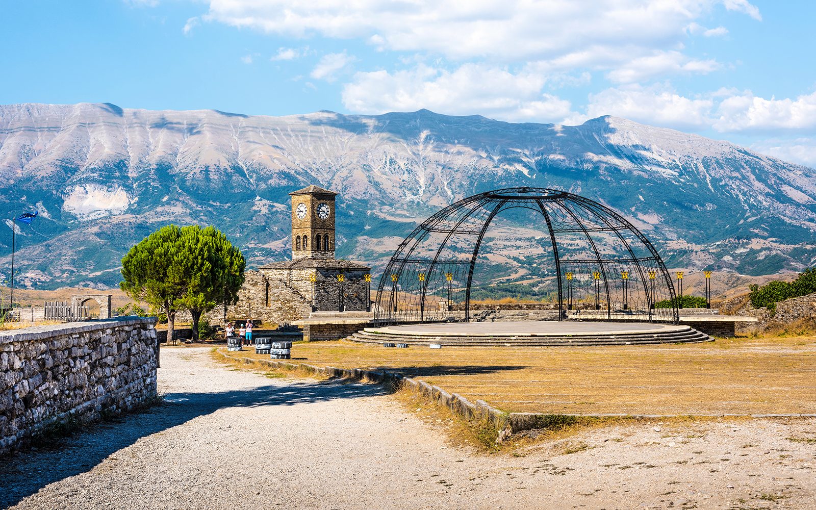 Gjirokaster Castle compound with clock tower and mountain backdrop, Albania.