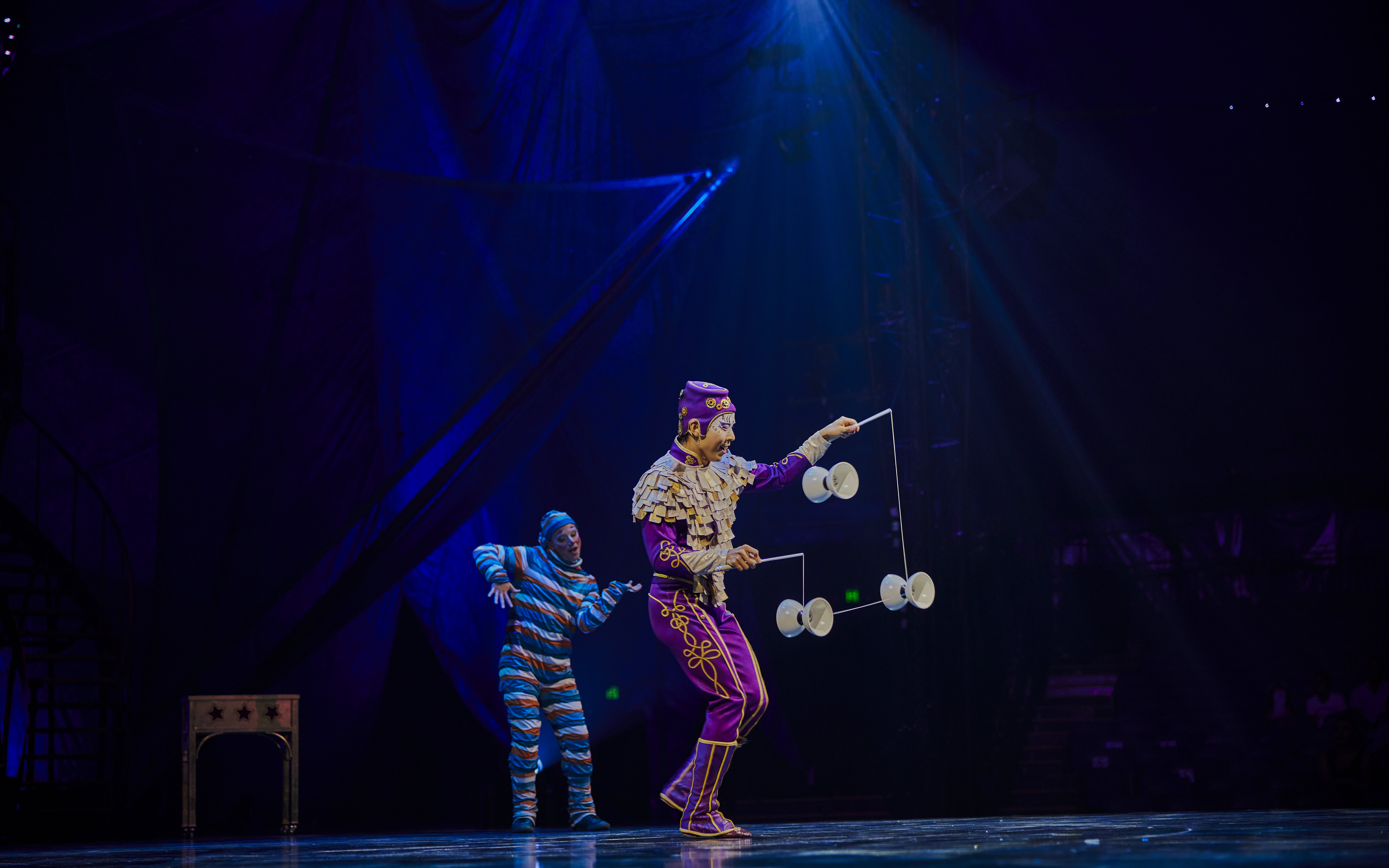 Performer juggling diabolos on stage during Kooza show in Brisbane.