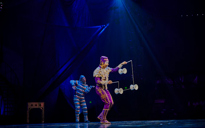 Performer juggling diabolos on stage during Kooza show in Brisbane.