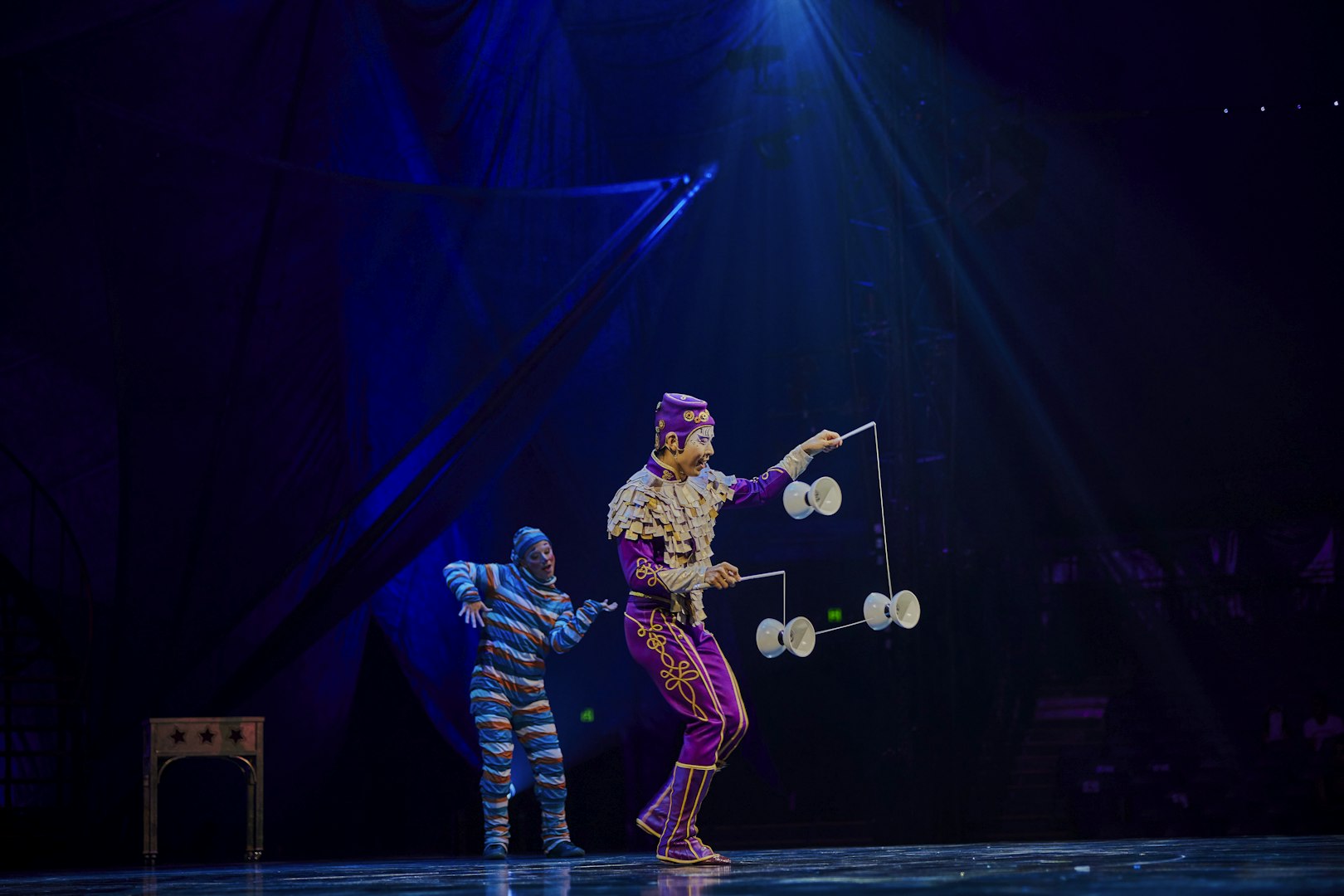 Performer juggling diabolos on stage during Kooza show in Brisbane.
