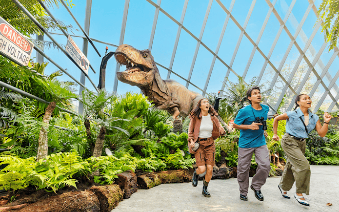 Visitors running from a dinosaur at Jurassic World experience, Gardens by the Bay.