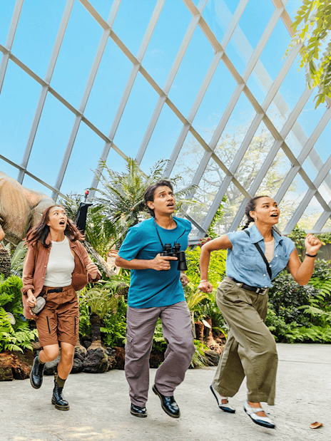Visitors running from a dinosaur at Jurassic World experience, Gardens by the Bay.