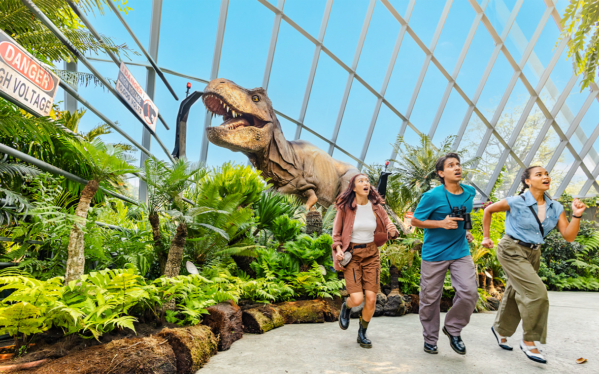 Visitors running from a dinosaur at Jurassic World experience, Gardens by the Bay.