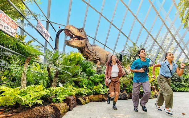 Visitors running from a dinosaur at Jurassic World experience, Gardens by the Bay.