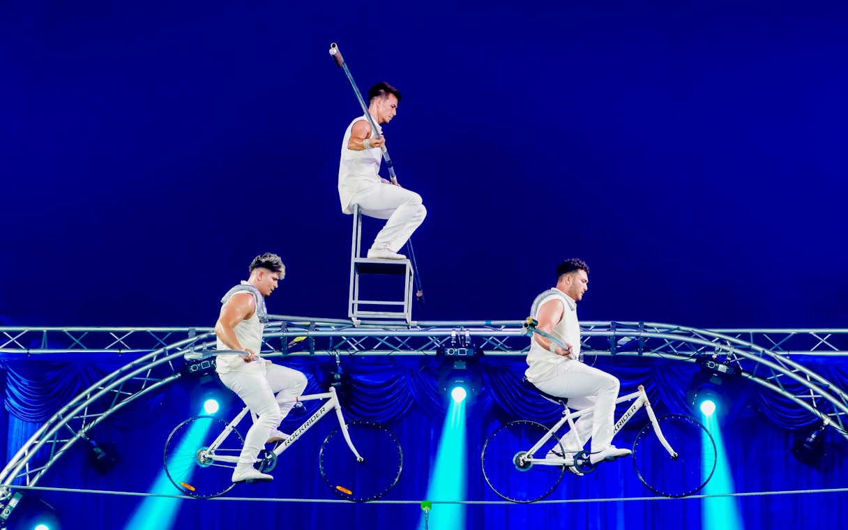 Acrobats performing on bicycles and a chair at Aqua Circus Phuket.