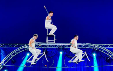 Acrobats performing on bicycles and a chair at Aqua Circus Phuket.